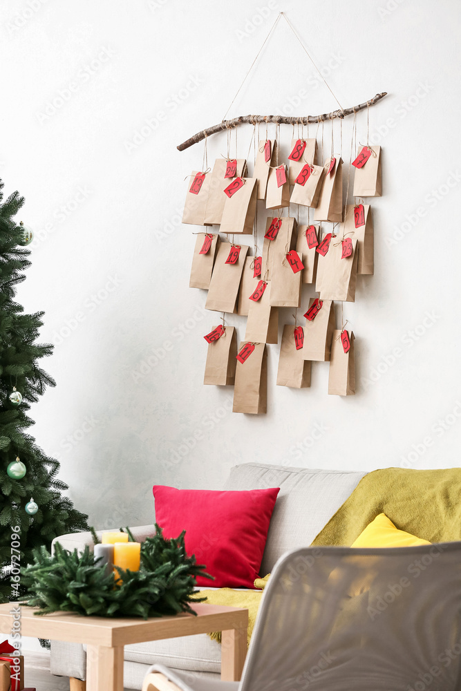 Christmas advent calendar hanging on light wall in room