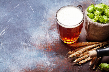 Poster - Lager beer mug, hops and wheat on old stone table