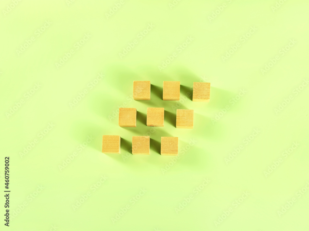 9 Block Sign Nine wooden blocks in the form of the stairs on the green background ...