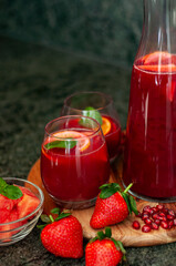 Healthy juice with strawberries, watermelon, pomegranate and orange