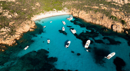Wall Mural - View from above, stunning aerial view of Mortorio island with a beautiful white sand beach and some boats and yachts floating on a turquoise, crystal clear water. Sardinia, Italy.