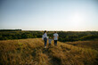 © Andrii - mom and dad run across the field holding their son's hands