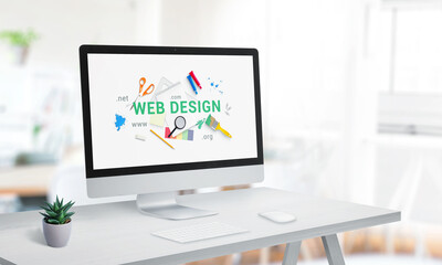 Wall Mural - Web design studio with computer display on office desk. Creative web page with web design text surrounded by tools concept