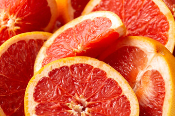 Wall Mural - Juicy Grapefruit slices on rustick dark background. Healthy food.