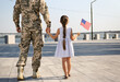 © New Africa - Soldier and his little daughter with American flag outdoors, back view. Veterans Day in USA