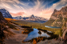 Scenic View Of Glacier Lake With Canadian Rocky Mountains In Background. Dramatic Fall Sunset Sky Art Render. Located In Lake O'Hara, Yoho National Park, British Columbia, Canada.