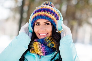 Sticker - Photo of happy joyful lady listen music wear earphones headwear scarf gloves coat in winter park outdoors