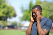 © PheelingsMedia - Black man suffering migraine in a park a sunny day