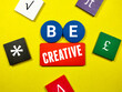 © Mohd Azrin - Colored wooden board written with text BE CREATIVE on yellow background.
