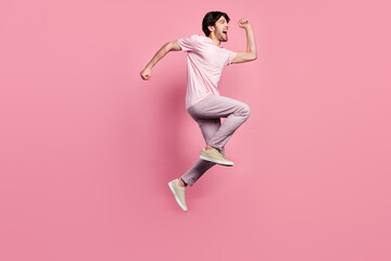 Canvas Print - Full body profile side photo of young man happy positive smile jump up go walk run isolated over pink color background