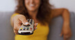 © StockPhotoPro - Happy woman pointing the TV remote control at the camera
