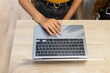© ADDICTIVE STOCK - Anonymous woman typing on laptop during workday
