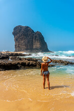 A Young Tourist With A Hat In The Roque Del Moro Of The Cofete Beach Of The Jandia Natural Park, Barlovento, South Of Fuerteventura, Canary Islands. Spain