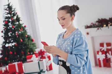 Canvas Print - Photo of serious young woman hold hands telephone read message xmas good mood indoors inside house