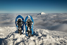 Blue Snowshoes On Tne Snow In The Mountains