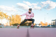 © ADDICTIVE STOCK - Female skater practicing stunt in park
