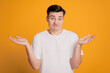 Portrait of clueless confused guy shrug shoulders grimace no answer on yellow background