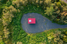 Top View Of Hut With Red Roof Surrounded By Green Trees