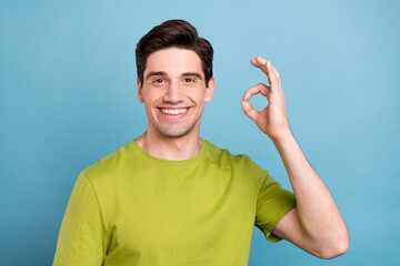 Poster - Portrait of attractive cheerful content guy showing ok-sign advert ad isolated over bright blue color background