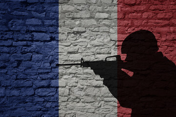 Soldier silhouette on the old brick wall with flag of france country.