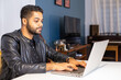 © Pedro - Brazilian black man with leather jacket working home office on computer