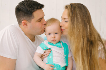 A beautiful young happy family with a one-year-old child, the Fa