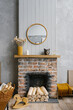 Scandinavian brick fireplace with wood and decor on it against the background of a gray wall of a country house