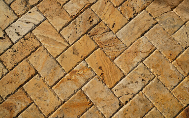 Wall Mural - Yellow brown stone pavers background. Neutral texture of a flat brick wall close-up.        