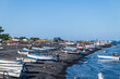 Stromboli island (Aeolian archipelago), Lipari, Messina, Sicily, Italy, 08.21.2021: view of the village   with many boats on the black lava beach.