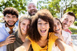 © Xavier Lorenzo - Happy multiracial friends taking a selfie portrait with mobile phone - Diverse group of young teenage students having great time together while hugging each other outdoors - Millennial people concept