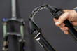 Repair of modern mountain bikes and shock-absorbing forks in a professional workshop. Parts of the fork are close-up on a black background. Bike maintenance before competitions.