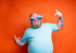 Fat delusion man with beard, tattoos and sunglasses is uncertain for something