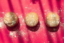 Three Muffins Decorated With Powdered Sugar, On A Pink Background, Food In Studio, Baked Dessert