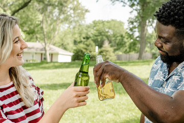 Wall Mural - Cheers with beer at a summer party in the park