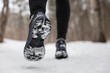 © Maridav - Winter exercise fitness lifestyle athlete walking with running shoes on snow and slippery ice needing traction soles on icy sidewalks. Run outside in cold weather.