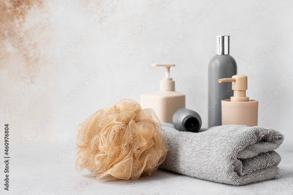Set of bath accessories and soft sponge on light background