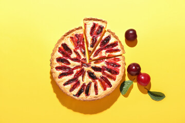 Tasty plum pie on color background