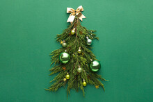 Christmas Tree Made Of Fir Branches And Decor On Green Background