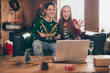 © deagreez - Photo of cheerful happy husband wife couple people talk wave hello computer call xmas eve indoors inside house home