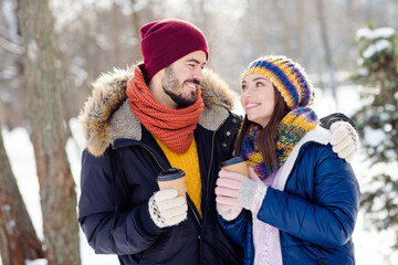 Wall Mural - Photo of cheerful man charming lady look each other hold tea toothy smile enjoy free time in woods outdoors