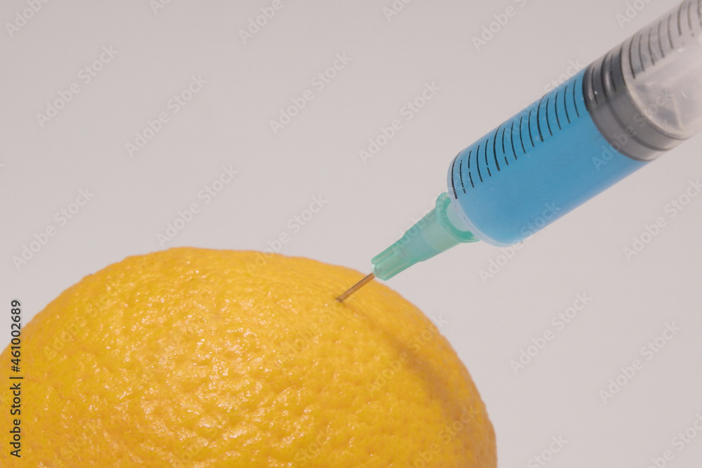 Poisoned foods. Poisoned lemon. Poisonous substance in a syringe. Blue ...