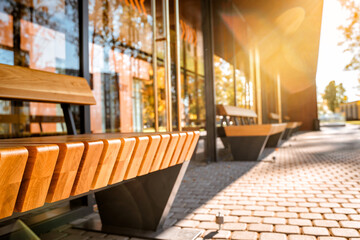 Stylish bus stop with wooden benches, modern architecture for the city