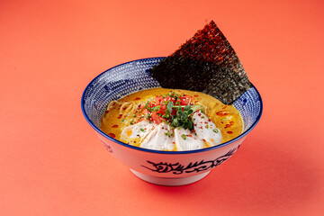 Wall Mural - Japanese curry chicken ramen with tomatoes on yellow background