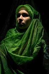 Saint Mary cosplay in green draping outdoors