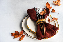 Autumnal Rustic Table Setting With Fall Foliage Decorations