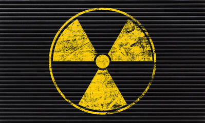 Wall Mural - Yellow radioactive sign over black background