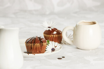 Wall Mural - homemade muffins served for breakfast or dessert, cupcakes on light white-grey background. 