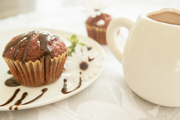 Wall Mural - homemade muffins served for breakfast or dessert, cupcakes on light white-grey background. 