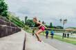 © qunica.com - Fit healthy athlete, beautiful woman in tight sportswear jumping on stairs, warming up before jogging while looking highly motivated..