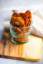 Sliced, Dried And Dehydrated Persimmon Fruit In A Glass With A Napkin